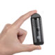 Cipher Herby Dry Herb Vaporizer in carbon black being held between two fingers to show size